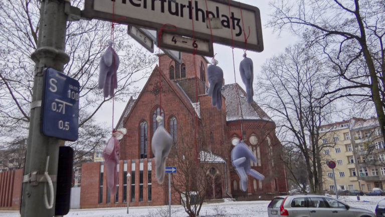 Gummihandschuhe am Straßenschild Foto Cloud Pictures